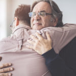 Son hugs his own father