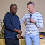 CDC 2024 Kohs praying with Ethiopian pastor