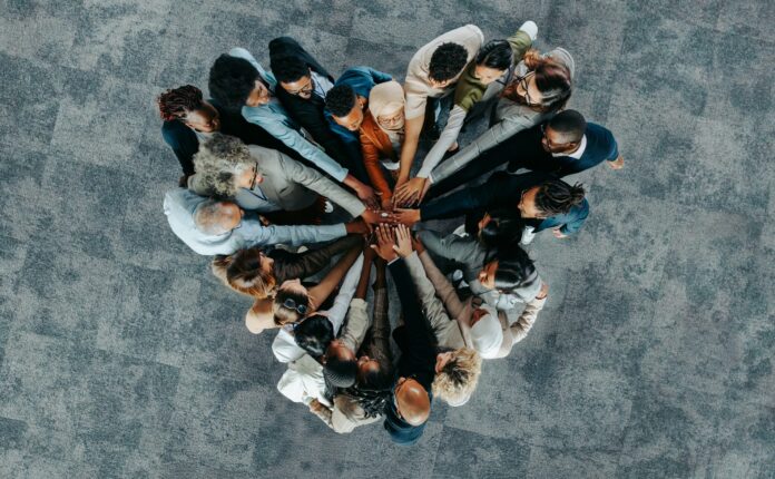 Top view of a a heart shape of people, showing unity and teamwork