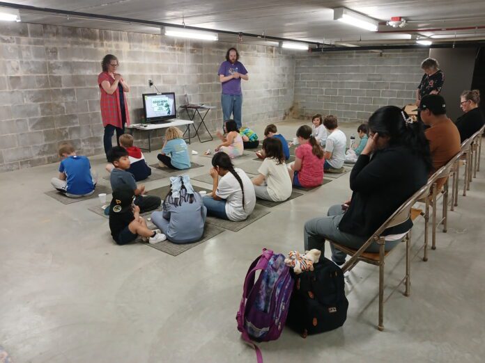 Bible Clubs 1 Two adults teach a group of students
