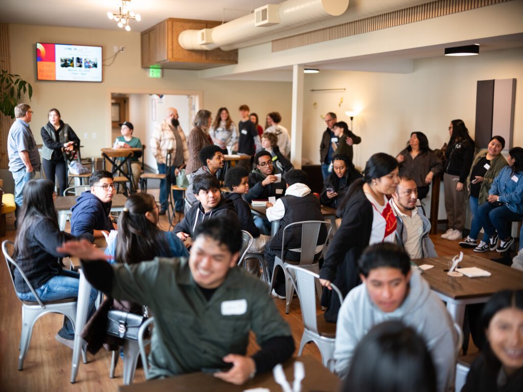 Students sit at tables together
