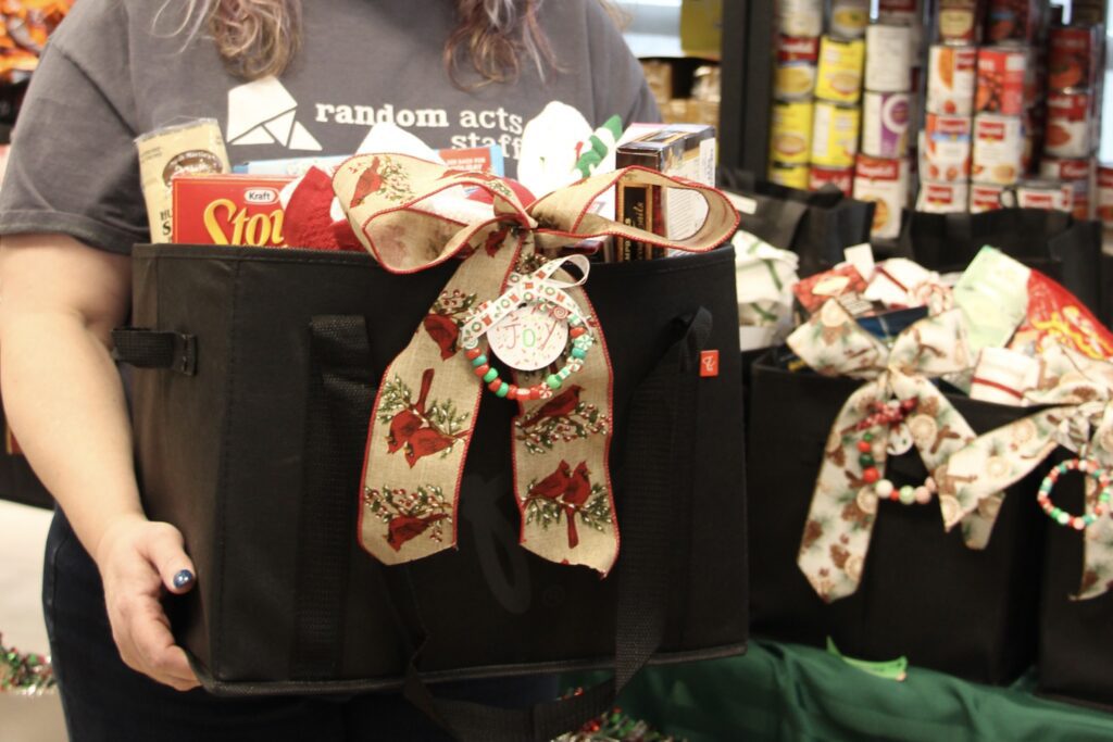 A bag filled with food and wrapped with a bow.