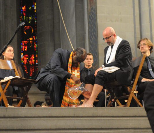 Reconciliation, blessing and gratitude Two men wash each other's feet.