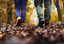 A comfortable disobedience Close up of two hikers feet walking in forest.