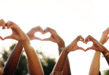 Showing appreciation Friends, people and team with heart hands outdoors.