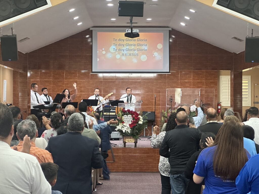 A worship team leads people in singing.