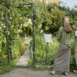 Woman and Girl Reading Information About Plant