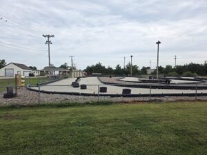 Fenced-in, outdoor track for go-kart racing with tires to divide lanes.