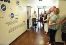 Finding new life Church members look at walls of church.