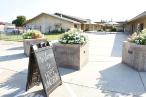 Courtyard entry to church with welcome sign.