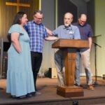 Man and woman stand at front of sanctuary.
