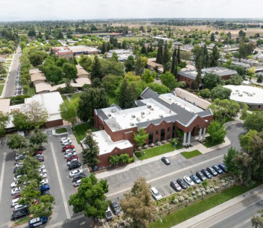 Collaborative grant strengthens relationship of Fresno Pacific Biblical Seminary, USMB Drone view of college campus buildings, parking lot, surrounding area.