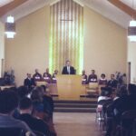 Man preaching in front of congregation.