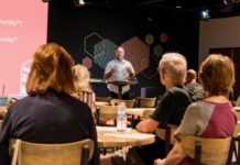 Living like Jesus Man speaking at podium in front of audience.