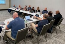 USMB boards meet, approve 2026 budget People sitting around tables.