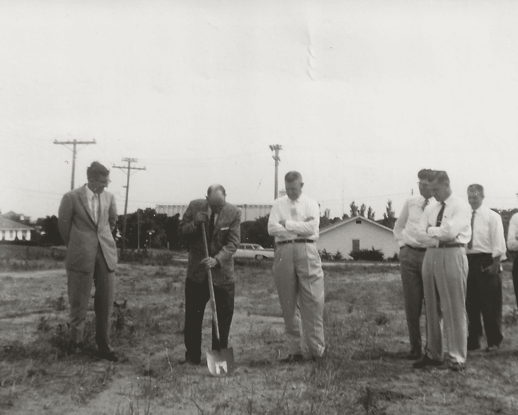 Men with shovel breaking ground.